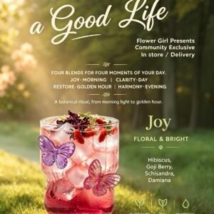 Handcrafted Joy botanical wellness drink, pink iced herbal beverage with hibiscus and goji berry, butterfly glass decoration, sunlit grass background, Flower Girl Wellness